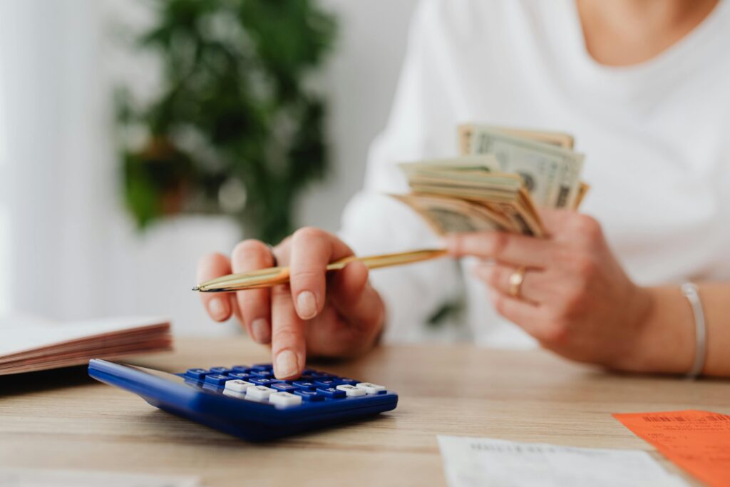 An image showing a mom and a calculator budgeting for her family.