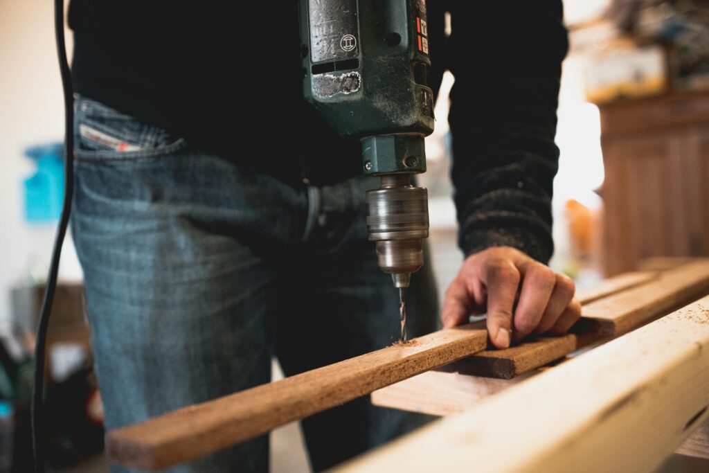 A man drilling wood for home improvement